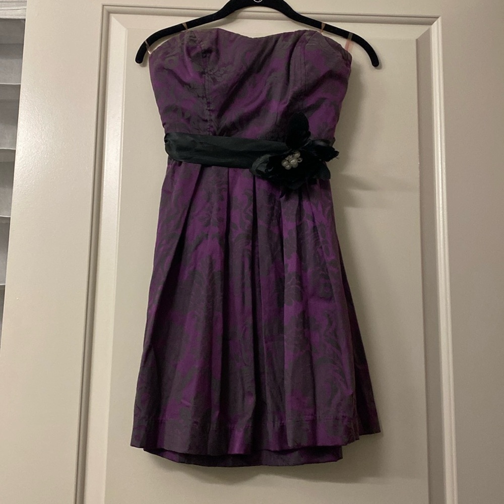 Vintage junior strapless dress has satin belt with flower embellishments.